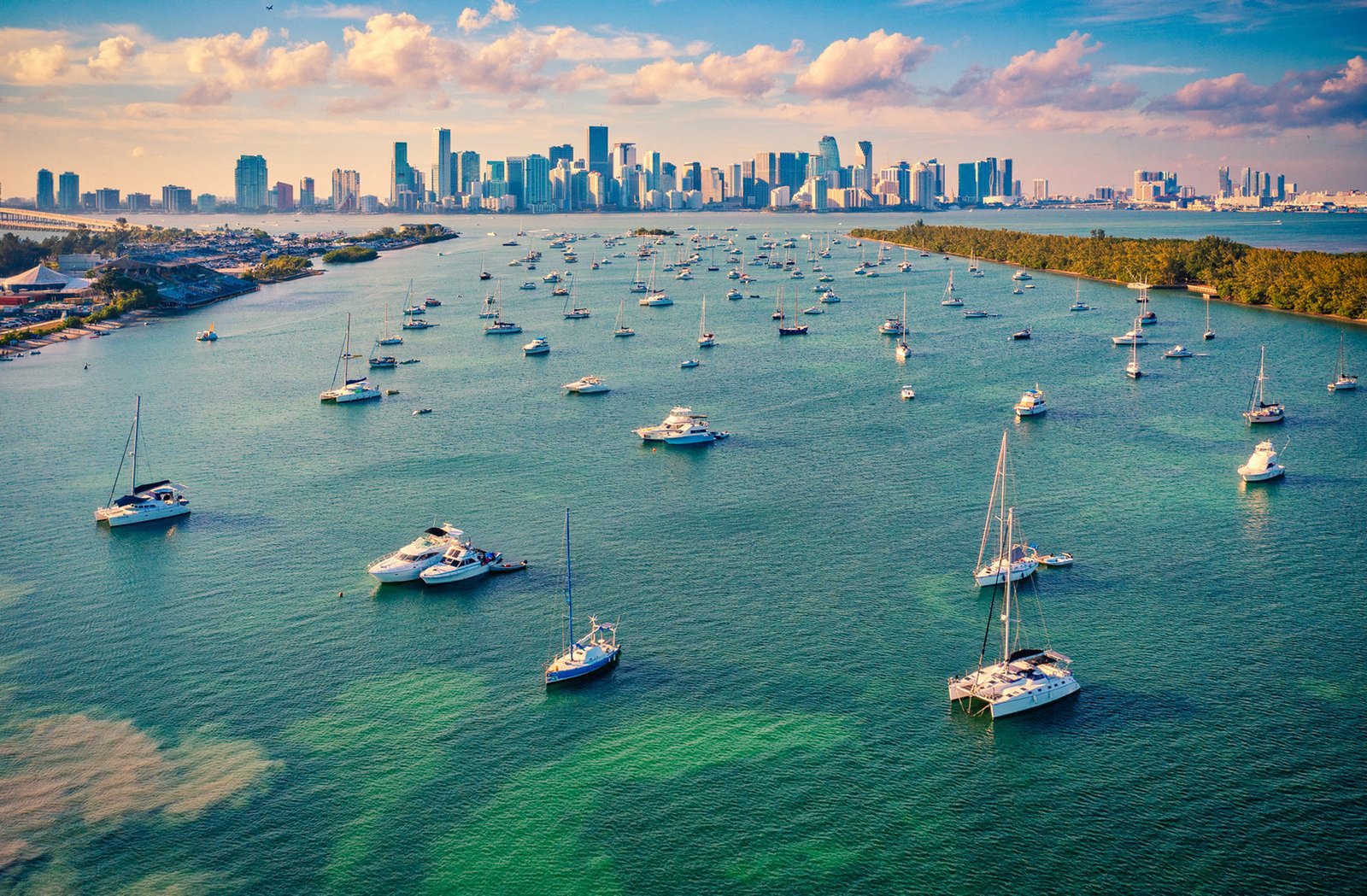 Boats and yachts moored in turquoise Biscayne Bay with mangrove islands beyond