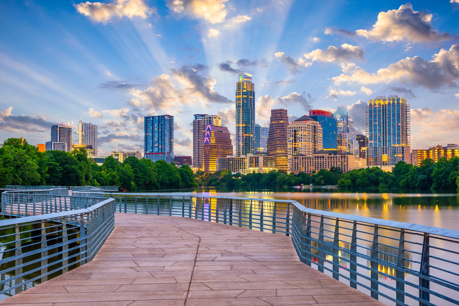 Austin skyline at dusk seen across Lady Bird Lake from the boardwalk